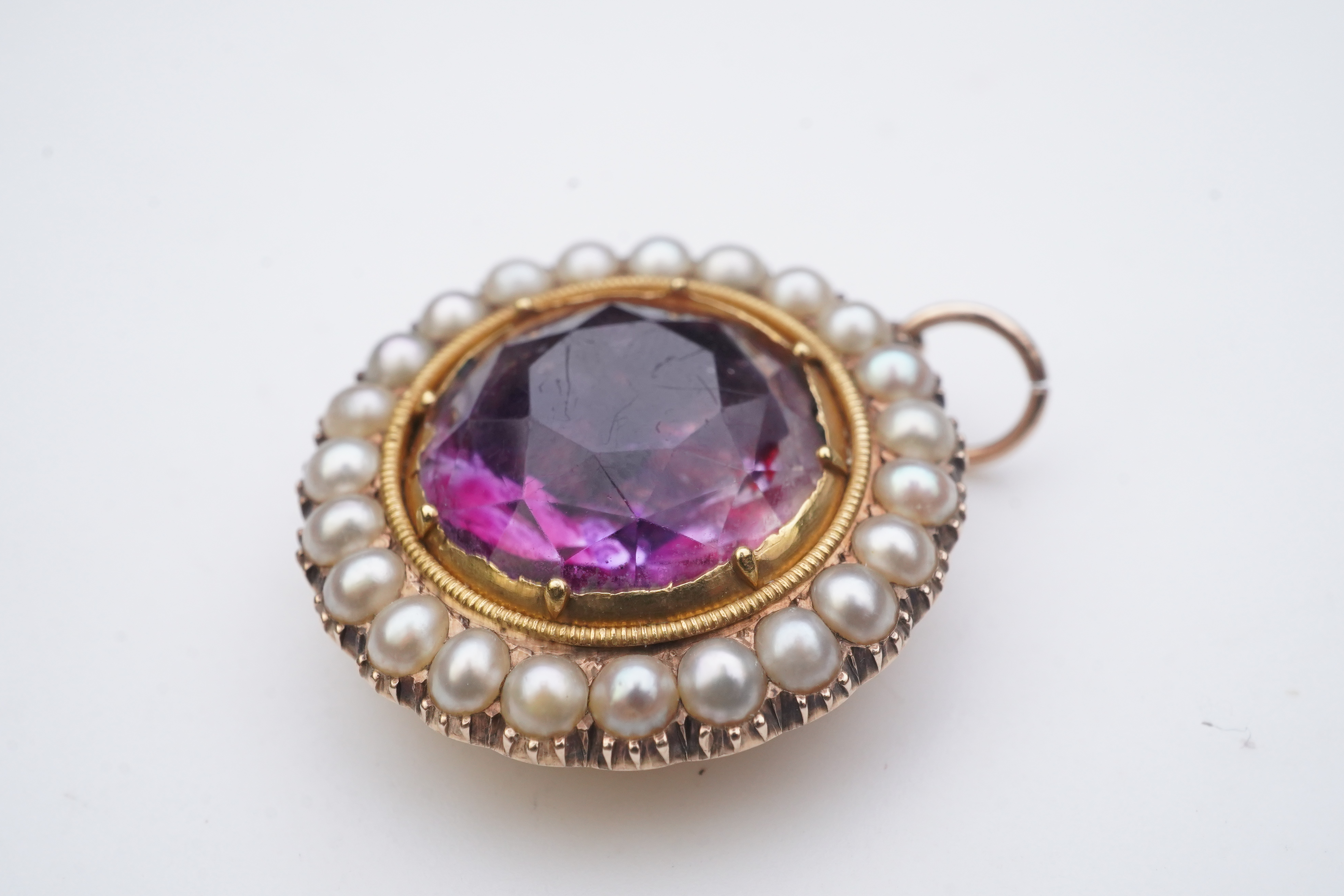 A Victorian amethyst and half pearl pendant, mid 19th century